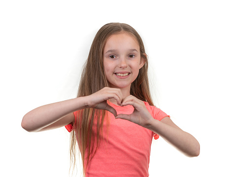 Young girl making heart shape with hands