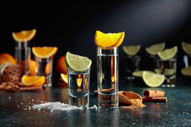 tequila shots on a black background. - shot glass glass alcohol color image imagens e fotografias de stock