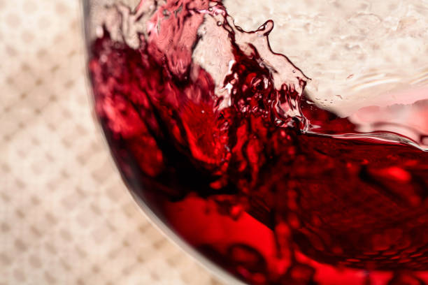 istock Red wine is poured into a glass. 1389136071