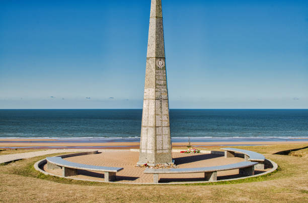 Omaha Beach, Colleville-sur-Mer, France, September 01, 2019:  Looking at the 1st US Infantry Division Memorial at Omaha Beach, Colleville-sur-Mer, Calvados, Normandy, France. The obelisk stands in the middle of the area of Wiederstandsnest (WN62). WN62 was one of the strongest defending positions in that area. The WN62-area is dotted with casemates, tobruks, trenches and other defense objects.