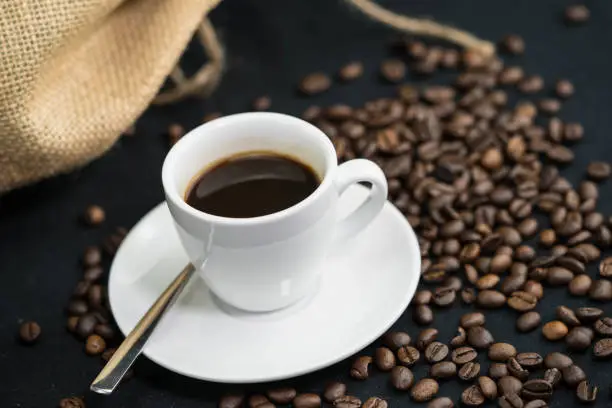 freshly roasted brewed coffee beans and an old coffee grinder