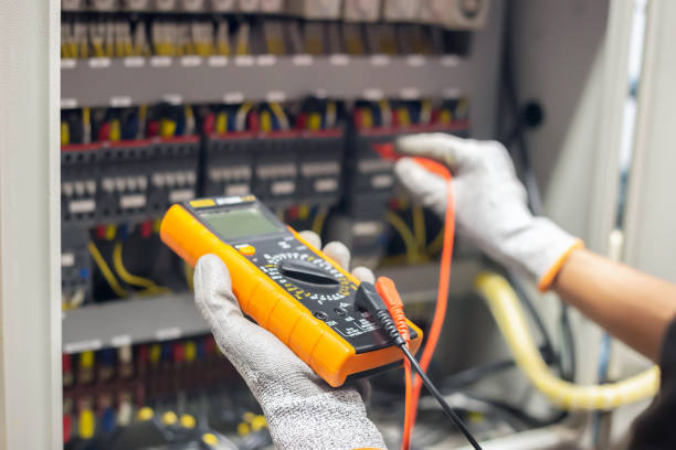 istock Electrician engineer uses a multimeter to test the electrical installation and power line current in an electrical system control cabinet. 1389142099