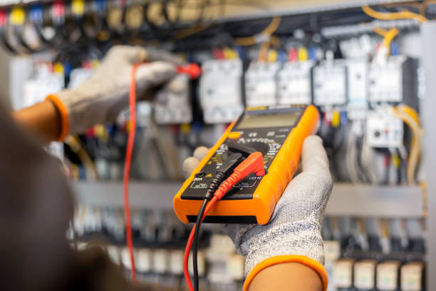 istock Electrician engineer uses a multimeter to test the electrical installation and power line current in an electrical system control cabinet. 1389142100