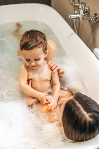 istock Mother taking a bath with her child 1389142499