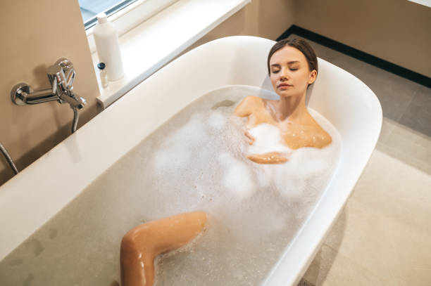 istock Beautiful calm woman dozing in the bath 1389142507