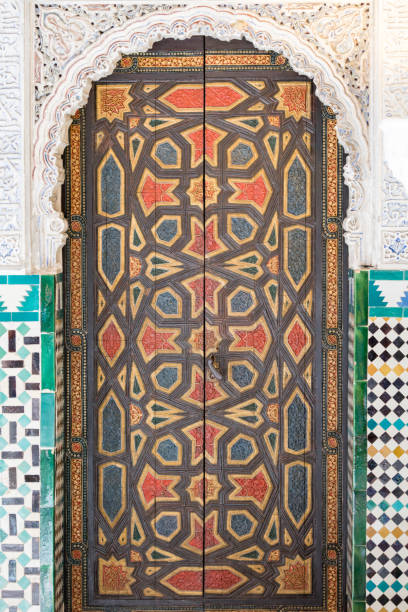 finely chiseled and decorated wooden door of the Alcazar Seville building Seville, Spain - May 10, 2018: finely chiseled and decorated wooden door of the Alcazar Seville building alcazar seville stock pictures, royalty-free photos & images