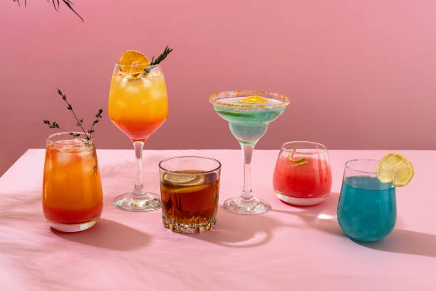 istock Colorful tropical cocktails. Refreshing colorful summer drinks on pink background with shadow palm leaf. Bar drinks menu. 1389144607