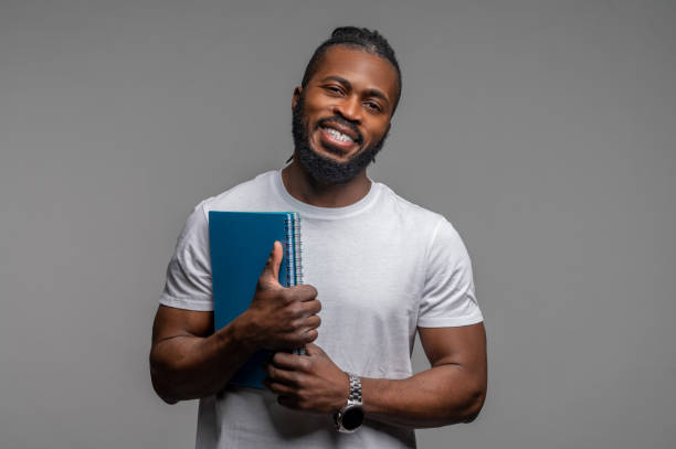 istock Cheerful male student posing for the camera 1389146196