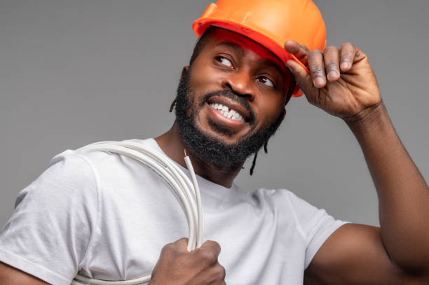 istock Worker with a wrapped cable over the shoulder looking away 1389146217