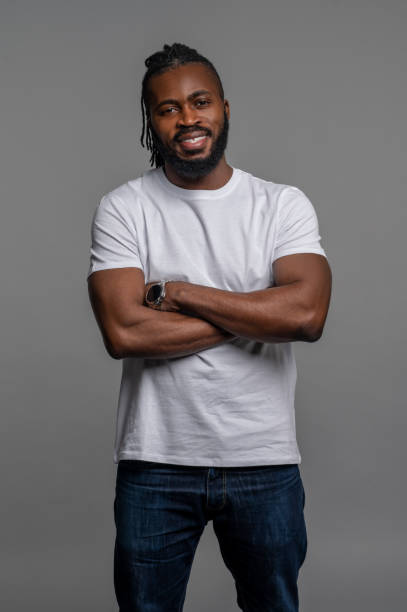 istock Cheerful guy posing for the camera against the gray background 1389146306