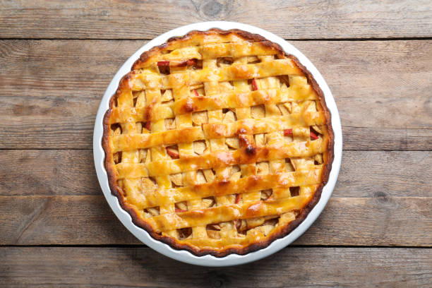 istock Traditional apple pie on wooden table, top view 1389150484