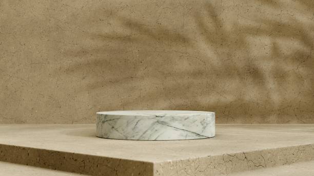 istock Beige concrete wall and floor with a white marble podium and palm leaf shadows 1389151106