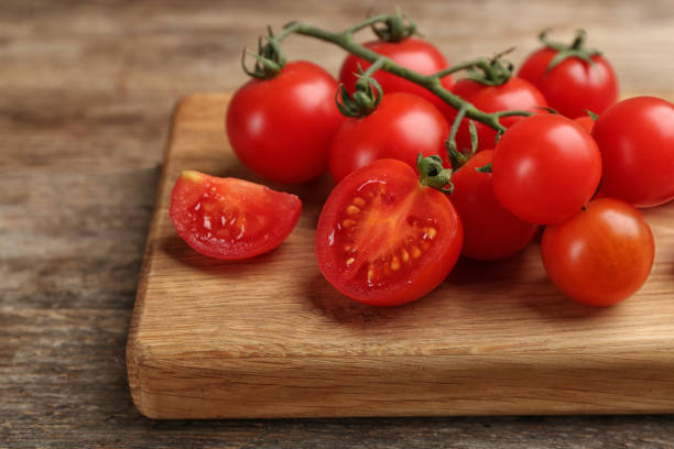 istock Fresh ripe cherry tomatoes on wooden table, closeup 1389151366