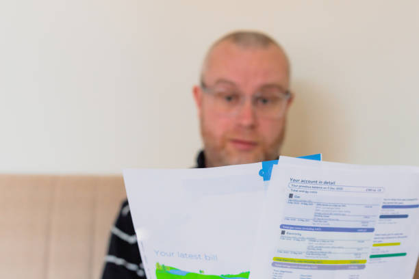istock Worried man checking bills at home 1389152903