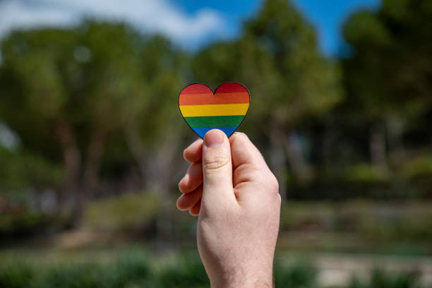 istock Gay man holding lgbt banner 1389152981