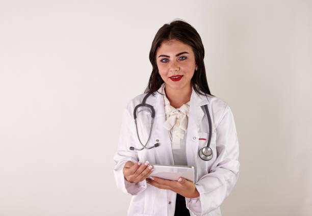 Female friendly cheerful Doctor or Nurse Isolated in white smiling and looking at camera