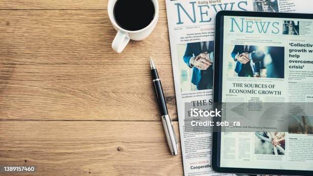 Newspaper And Digital Tablet On Wooden Table Stock Photo - Download Image Now - Newspaper, The Media, News Event