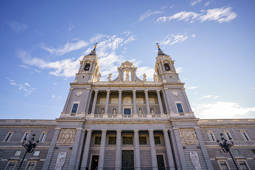Almudena Cathedral in the city of Madrid during a sunny day with a clear sky from the street