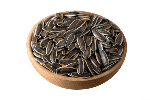 istock Sunflower seeds in a bowl on white background,top view 1389159652