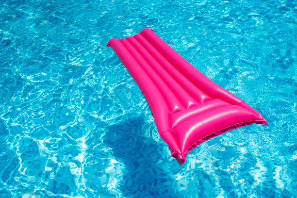 istock Raspberry air mattress in the pool. Summer holiday concept. 1389161484