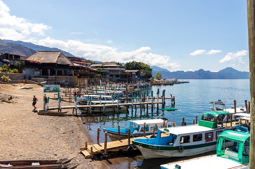 panajachel, solola, Guatemala; 03-28-2022: Many boats waiting for passengers in wooden piers on the shore of lake atitlan