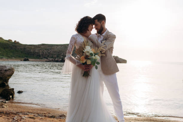 istock Wedding on the sunset with live floristry. Bride and groom in boho style. 1389161788