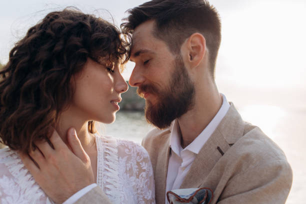 Wedding on the sunset with live floristry. Bride and groom in boho style.