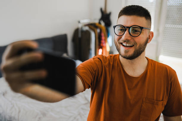 istock Man having video call by smart phone from his bedroom 1389162947