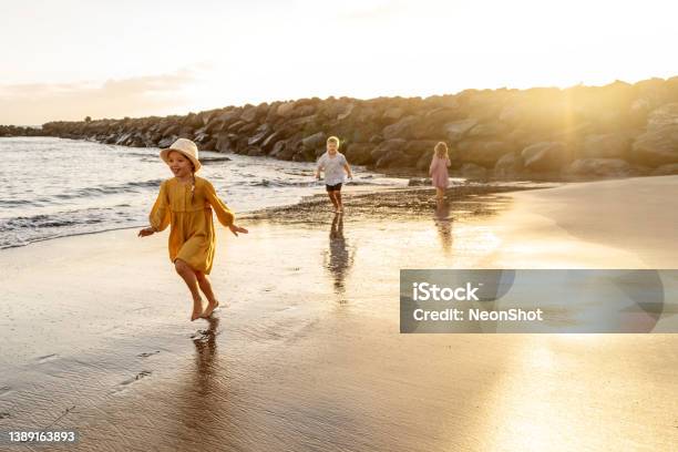 Kids Playing On The Beach Family Summer Vacation Vibes Stock Photo - Download Image Now
