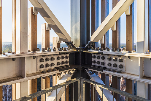 Detail of steel screw bolts connecting massive industrial steel construction.