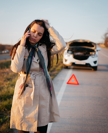 The woman calls the roadside assistance service.