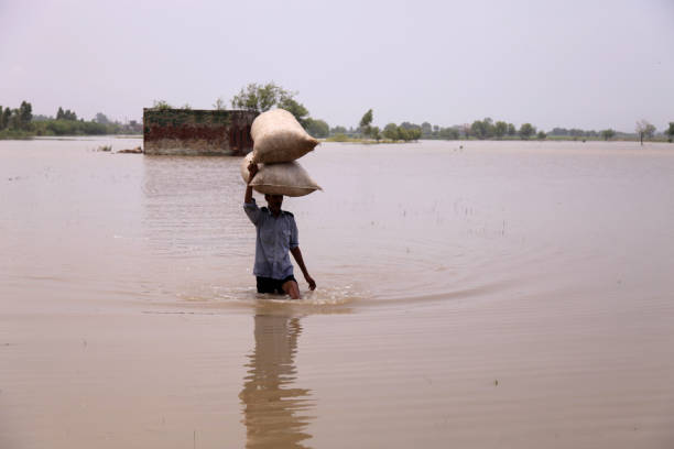 Farmer carrying sack during rainy season