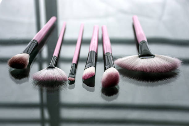 pink makeup brushes with acrylic and glass background