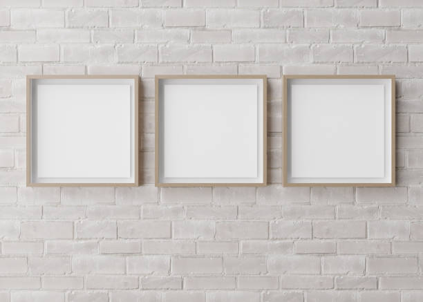 istock Three blank square picture frames hanging on white brick wall. Template, mock up for your picture or poster. Copy space. 3D rendering. 1389167618