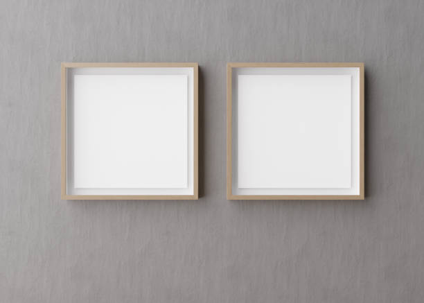 istock Two blank square picture frames hanging on gray concrete wall. Template, mock up for your picture or poster. Copy space. 3D rendering. 1389167621