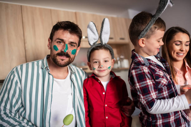 istock Happy family painting their faces on Easter 1389168566