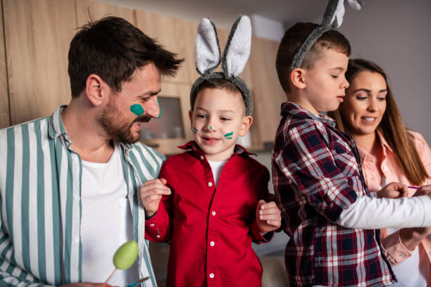 istock Young family painting Easter eggs 1389168629