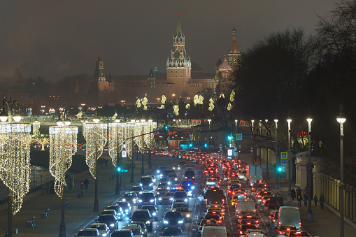 Moscow, Russia - December 24, 2019: Kremlin Spasskaya Tower, Saint Basil's Cathedral (Cathedral of Vasily the Blessed). Zaryadye park during coronavirus pandemic. Motorway is filled out cars