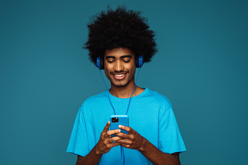 African american man with african hairstyle using phone