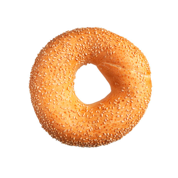 istock Fresh round wheat bagel with sesame seeds isolated on white background. Crispy bread, healthy organic food, traditional pastries, bakery product. Breakfast bagel, cut out element for advertising 1389175021