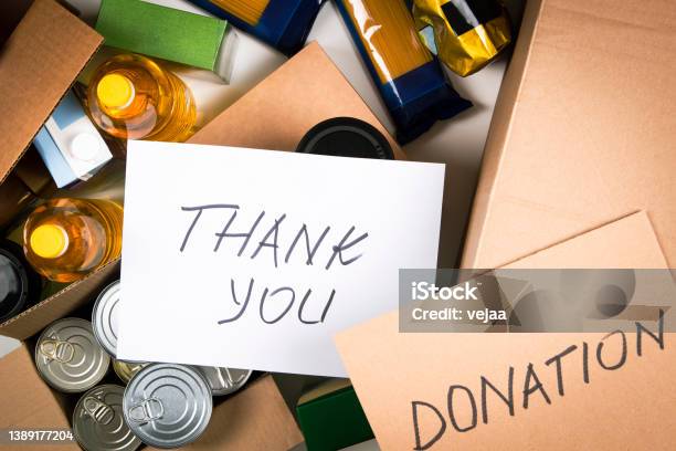 Food Donations Boxes With Grocery Products And Cards With Inscription Donation And Thank You Cardboard Boxes With Oil Canned Food Cereals Pasta Water Top View Stock Photo - Download Image Now