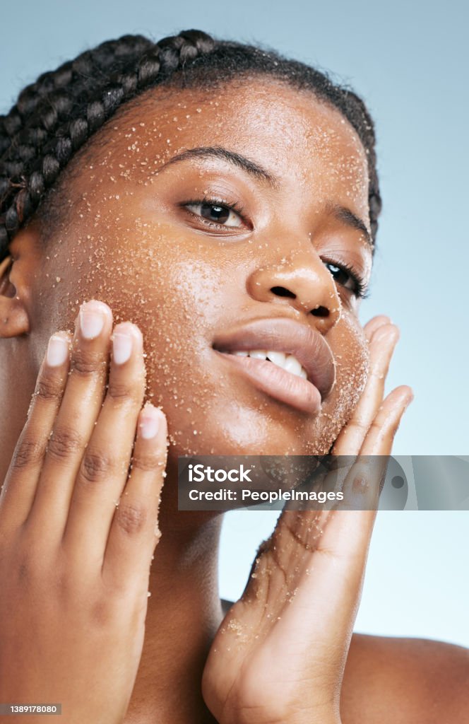 Cropped shot of an attractive young woman posing in studio against a grey background For clear and healthy skin Exfoliation Stock Photo