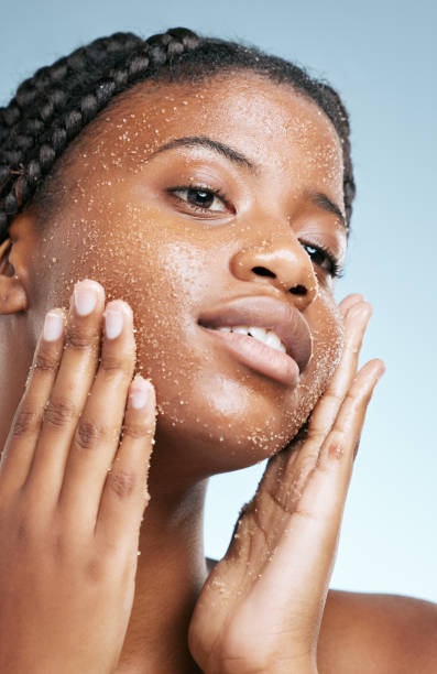 Cropped shot of an attractive young woman posing in studio against a grey background For clear and healthy skin exfoliating scrub stock pictures, royalty-free photos & images