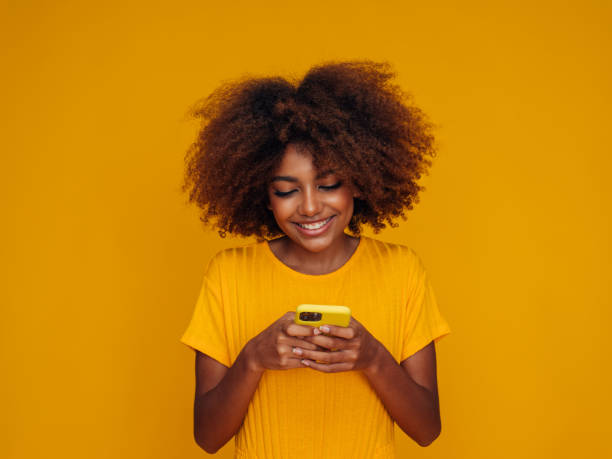 istock Woman holding a smart phone 1389180097