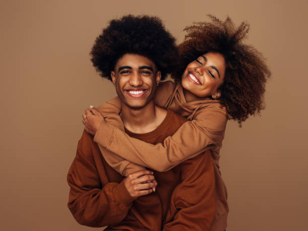Happy brother and sister with afro hairstyle stock photo