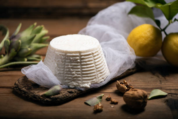 Fresh ricotta cheese on wooden background stock photo
