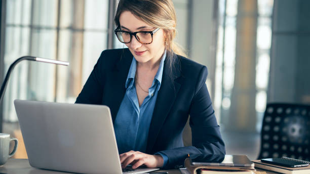 istock Young businesswoman using laptop computer in the office 1389183378