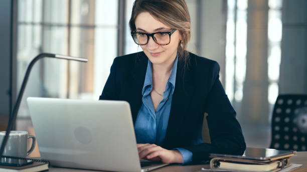 istock Young businesswoman using laptop computer in the office 1389183392