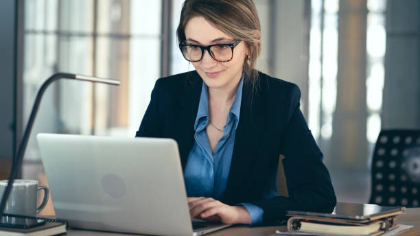 Young businesswoman using laptop computer in the office stock photo