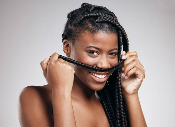 Cropped portrait of an attractive young woman posing in studio against a brown background I don't think so... black hair braiding stock pictures, royalty-free photos & images